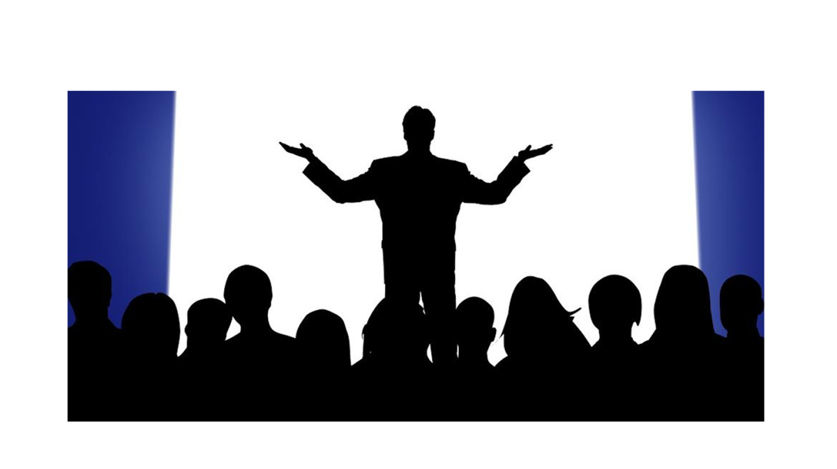 A silhouette of a person standing in front of a group of people Description automatically generated